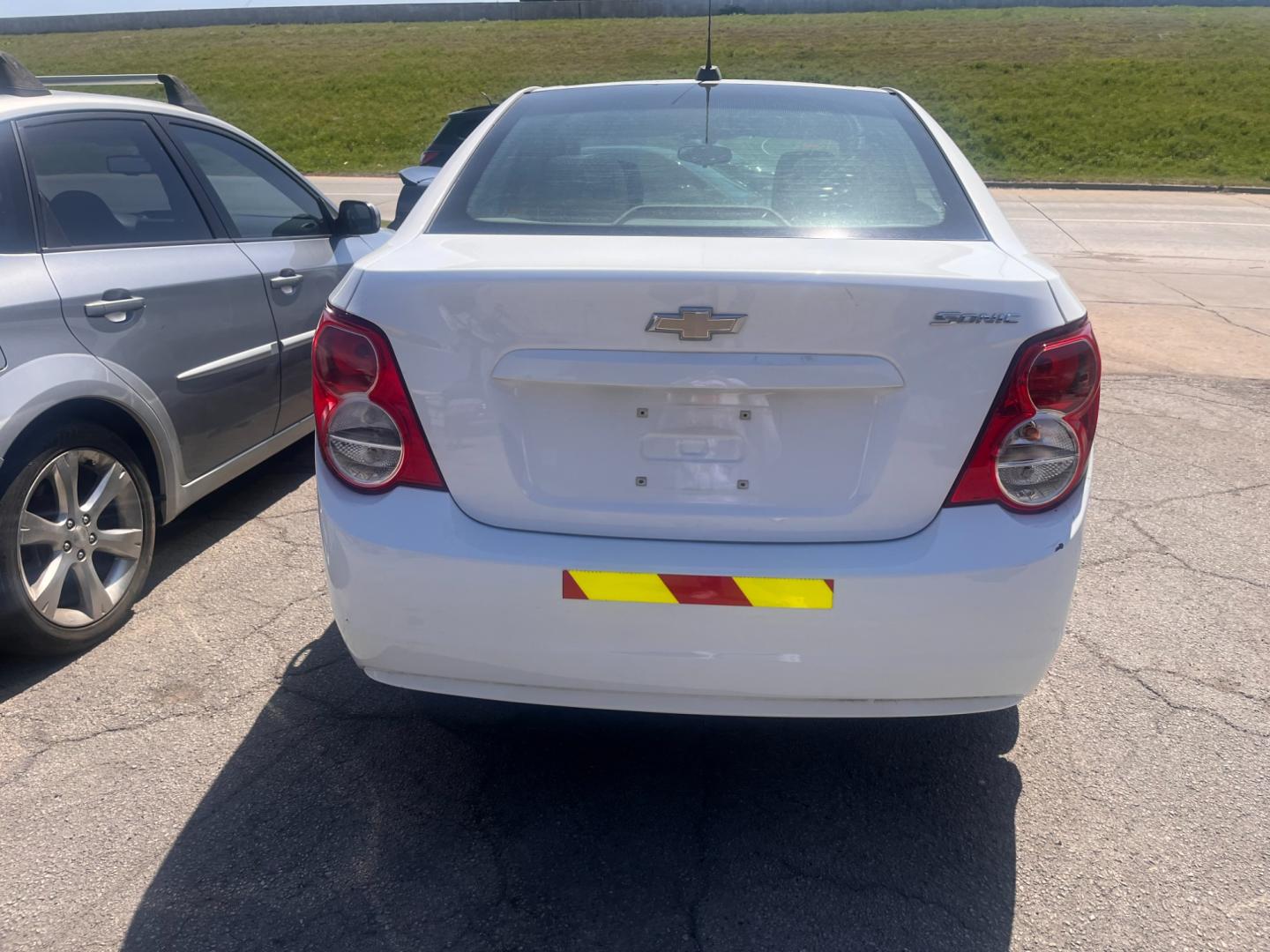 2016 WHITE CHEVROLET SONIC LS LS Auto Sedan (1G1JA5SH9G4) with an 1.8L L4 DOHC 24V engine, 6A transmission, located at 8101 E. Skelly Dr., Tulsa, OK, 74129, (918) 592-3593, 36.121891, -95.888802 - Photo#2